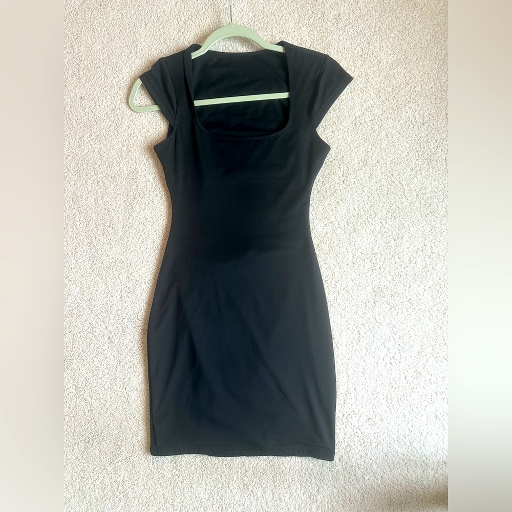 Little black dress with back cutout.